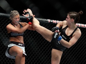 Ashley Yoder (left) blocks a kick from Mackenzie Dern during their women's strawweight bout during UFC 222 at T-Mobile Arena on March 3, 2018 in Las Vegas, Nevada. Dern won by split decision.