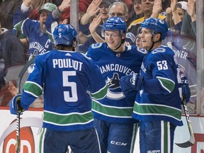 Jake Virtanen celebrates with teammates Derrick Pouliot and Bo Horvat after scoring a goal against the Coyotes on April 5, 2018, at Rogers Arena in Vancouver.