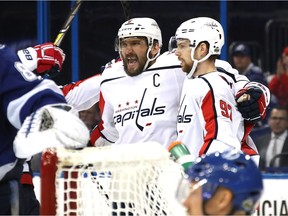 Alex Ovechkin celebrates with teammate Evgeny Kuznetsov after scoring a goal against the Tampa Bay Lightning.