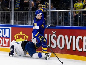 France's Florian Chakiachvili falls after a hit by Sweden's Elias Pettersson (R) during the group A match Sweden vs France of the 2018 IIHF Ice Hockey World Championship at the Royal Arena in Copenhagen, Denmark, on May 7, 2018.