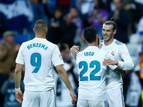 TOPSHOT - Real Madrid's Welsh forward Gareth Bale (R) celebrates goal during the Spanish league football match between Real Madrid and Celta Vigo at the Santiago Bernabeu Stadium in Madrid on May 12, 2018.