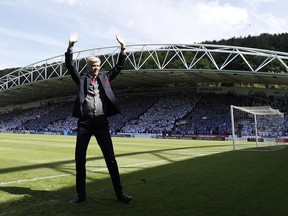 Arsenal's French manager Arsene Wenger waves from the pitch before the English Premier League football match between Huddersfield Town and Arsenal at the John Smith's stadium in Huddersfield, northern England on May 13, 2018.