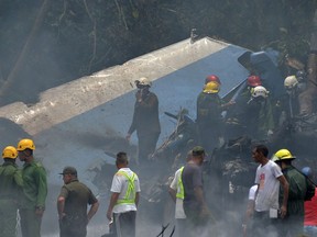 Emergency personnel work at the site of the accident after a Cubana de Aviacion aircraft crashed after taking off from Havana's Jose Marti airport on May 18, 2018. A Cuban state airways passenger plane with 113 people on board crashed on shortly after taking off from Havana's airport, state media reported.