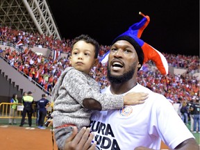 Costa Rica's Kendall Waston celebrates with his son, Keysaack, after qualifying for the FIFA 2018 World Cup, in San Jose, Costa Rica, on Oct. 7, 2017.