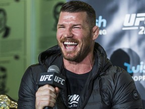 UFC champ Michael Bisping, who will fight challenger Georges St-Pierre (not pictured), laughs during a promotional press conference held at the Hockey Hall of Fame in Toronto on Oct. 13, 2017