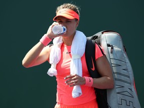 Eugenie Bouchard of Canada walks off court after losing in the final qualifying round against Rebecca Peterson of Sweden during the Miami Open Presented by Itau at Crandon Park Tennis Center on March 20, 2018