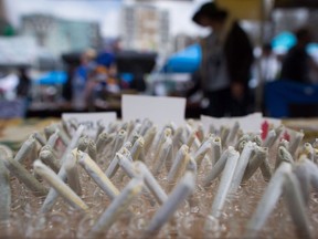 Joints are displayed for sale during the annual 4-20 cannabis culture celebration at Sunset Beach in Vancouver, B.C., on Thursday, April 20, 2017. Craft cannabis growers and sellers in British Columbia want immediate action from the federal and provincial governments to protect the future of the sector, ahead of expected legalization this year.