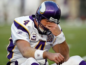 In this Oct. 31, 2010, file photo, Minnesota Vikings quarterback Brett Favre rubs his eyes after being hit by New England Patriots linebacker Gary Guyton during the first quarter of an NFL football game in Foxborough, Mass.