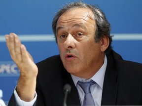 Michel Platini gestures as he speaks during a UEFA press conference after the draw for the UEFA Europa League football group stage 2015/16 on Aug. 28, 2015