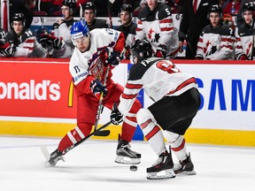 Lukas Jasek, playing with Team Czech Republic at the World Junior Championship in Montreal last January, takes a shot near Dante Fabbro of Team Canada. Jasek is in the Canucks' system and is projected as a bottom-six forward.