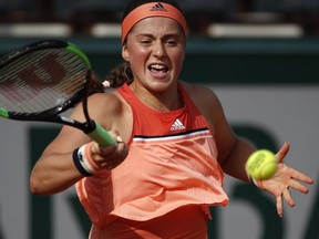 Latvia's Jelena Ostapenko returns the ball to Ukraine's Kateryna Kozlova during their first round match of the French Open at the Roland Garros Stadium in Paris, Sunday, May 27, 2018.