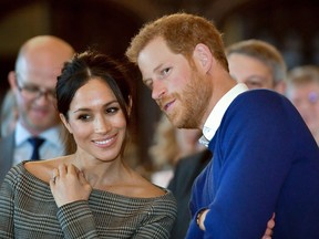 In this file photo taken on January 18, 2018 Britain's Prince Harry and his fiancÈe US actress Meghan Markle watch a dance performance by Jukebox Collective during a visit at Cardiff Castle in Cardiff, south Wales on January 18, 2018.