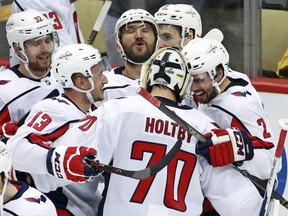 FILE - In this May 7, 2018, file photo, Washington Capitals goaltender Braden Holtby (70) celebrates with Evgeny Kuznetsov (92), Jakub Vrana (13), Alex Ovechkin, top center, and Matt Niskanen (2) after Kuznetsovs' game-winning goal during the overtime period in Game 6 of an NHL second-round hockey playoff series against the Pittsburgh Penguins in Pittsburgh. Alex Ovechkin is finally past the second round of the playoffs.
