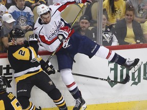 Pittsburgh Penguins' Chad Ruhwedel (2) collides with Washington Capitals' Tom Wilson (43) during the first period in Game 3 of an NHL hockey second-round playoff series in Pittsburgh, Tuesday, May 1, 2018.