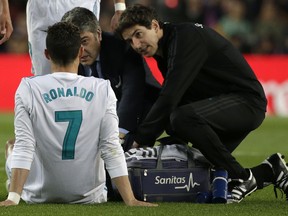 Real Madrid's Cristiano Ronaldo is treated for an injury after scoring his side's first goal during a Spanish La Liga soccer match between Barcelona and Real Madrid, dubbed 'El Clasico', at the Camp Nou stadium in Barcelona, Spain, Sunday, May 6, 2018.