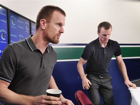Daniel  and Henrik Sedin moved quickly to their seats as they announced their retirement on April 9.
