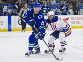 Canucks prospect Olli Juolevi works the puck in front of the Oilers' Joe Gambardella during the Young Stars game in Penticton in September 2017.