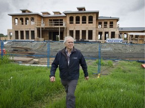 Harold Steves, a Richmond councillor and farmer, in front of a 'Mega house' under construction on No. 4 Road in the city.
