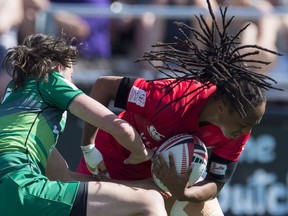 Canada's Charity Williams scores a try despite the efforts of Ireland's Hannah Tyrell during the World Rugby Women's Sevens Series in Langford, B.C., Sunday, May, 13, 2018.