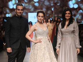Bollywood actress Kanagana Ranaut walks the runway for leading Indian designers Shyamal & Bhumika at Lakme Fashion Week in India. Shyamal Shodhan, left, was in B.C. to talk style and showcase his latest collection at House of Raina in Surrey.