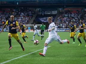 Vancouver Whitecaps' Marcel de Jong (in white) in action for the Vancouver Whitecaps during a March 2017 CONCACAF Champions League game against the New York Red Bulls at B.C. Place Stadium.