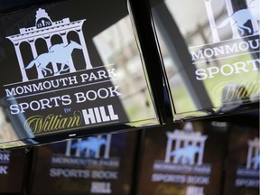 Signs for Monmouth Park are displayed in a bar at the racetrack in Oceanport, N.J., on May 14. The U.S. Supreme Court on Monday gave its go-ahead for states to allow gambling on sports across the nation, striking down a federal law that barred betting on football, basketball, baseball and other sports in most states.