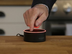 A man pushes down on an Echo Dot in San Francisco.