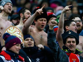 In this Friday, March 23, 2018 file photo, Russia supporters gesture on the stands during an international friendly soccer match between Russia and Brazil at the Luzhniki stadium in Moscow, Russia