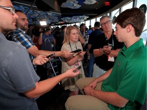 Quinn Hughes, selected seventh overall in Friday's NHL Entry Draft by the Vancouver Canucks, talks with reporters at Reunion Tower in Dallas, Texas.