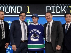 DALLAS, TX - JUNE 22:  Quinton Hughes poses after being selected seventh overall by the Vancouver Canucksduring the first round of the 2018 NHL Draft at American Airlines Center on June 22, 2018 in Dallas, Texas.