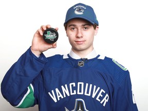 DALLAS, TX - JUNE 22:  Quinn Hughes poses after being selected seventh overall by the Vancouver Canucks during the first round of the 2018 NHL Draft at American Airlines Center on June 22, 2018 in Dallas, Texas.