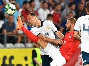 Russia's Sergei Ignashevich, left, and Austria's Guido Burgstaller vie for a ball during their friendly at Tivoli stadium in Innsbruck on May 30.