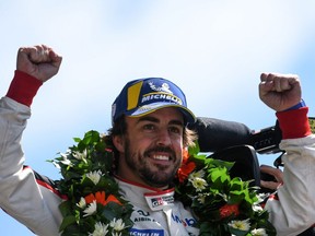 Spanish driver Fernando Alonso celebrates on the podium after he and his co-drivers won the 86th Le Mans 24-hours endurance race, at the Circuit de la Sarthe on Sunday, June 17, 2018 in Le Mans, France.