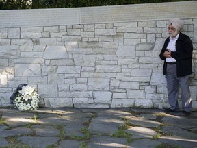 A man listens to the speakers as he attends the annual Air India memorial service at the Memorial wall in Vancouver's Stanley Park on Saturday, June 23.
