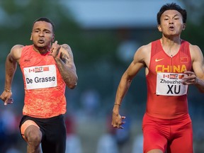 China's Xu Zhouzheng, right, races to a second-place finish ahead of Andre De Grasse, left, of Toronto, who finished third, during the Canada-China challenge men's 100 metre race at the Harry Jerome International Track Classic, in Burnaby, B.C., on Tuesday, June 26, 2018.