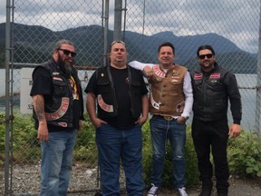 Burnaby firefighter NIck Elmes, right, poses with members of the Hells Angels.