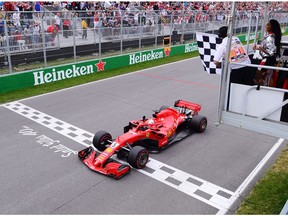 Ferrari driver Sebastian Vettel (5) of Germany crosses the finish line to win the Canadian Grand Prix Sunday, June 10, 2018 in Montreal.