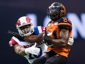 Jeremiah Johnson of the B.C. Lions is tackled by Montreal Alouettes' Henoc Muamba during Saturday's CFL game at B.C. Place Stadium. Both teams, which missed the playoffs last year, opened their regular-season in Vancouver with an entertaining game.