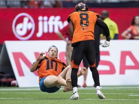 B.C. Lions' Marcell Young (8) knocks down a spectator that ran onto the field of play during the first half of a CFL football game against the Montreal Alouettes in Vancouver, on Saturday June 16, 2018.