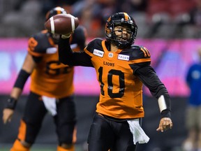 B.C. Lions quarterback Jonathon Jennings looks to pass while running with the ball during the first half of a pre-season CFL football game against the Winnipeg Blue Bombers in Vancouver on Friday. Coach Wally Buono wants Jennings to improve his game this year.