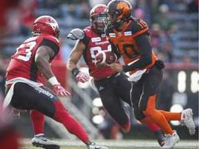B.C. Lions' quarterback Jonathon Jennings, right, runs the ball past Calgary Stampeders during CFL pre-season football action in Calgary on Friday. Ricky Lloyd stepped in later and delivered three touchdowns for the visitors.