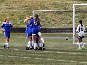 Members of the Coquitlam-based Centennial Centaurs converge on Sophia Ferreira, who scored the only goal Centennial would need — in overtime, no less — in beating Surrey’s Fleetwood Park 1-0 in overtime and capturing the B.C. Triple-A girls soccer championship last week at UBC.