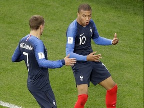 France's Kylian Mbappe, right, celebrates after scoring a goal against Peru with teammate Antoine Griezmann, left, during 2018 World Cup action in the Yekaterinburg Arena in Yekaterinburg, Russia, Thursday, June 21, 2018.