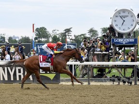 Justify, ridden by Mike Smith, wins the Triple Crown and the 150th running of the Belmont Stakes on Saturday, June 9, 2018, at Belmont Park in Elmont, N.Y.