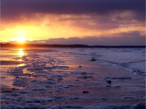 File photo: The sun sets over North Beach near the village of Massat on the northern end of Queen Charlotte Islands March 8, 2002.