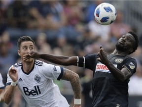 C.J. Sapong of the Philadelphia Union, right, and Vancouver Whitecaps' Jose Aja chase the ball during first half MLS action on Saturday in Chester, Pa. Vancouver lost 4-0.