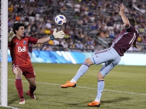 Vancouver Whitecaps goalkeeper Brian Rowe defends shot by Colorado Rapids midfielder Shkelzen Gashi (11) during the second half of Friday's game in Commerce City, Colo. Vancouver won 2-1.