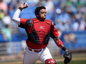 Canada Junior National Team catcher Noah Naylor makes the play to first during the second inning of a spring training baseball game against the Toronto Blue Jays Saturday, March 17, 2018, in Dunedin, Fla.