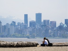 Two ladies enjoy the sunshine at Spanish Banks Beach in Vancouver, BC.