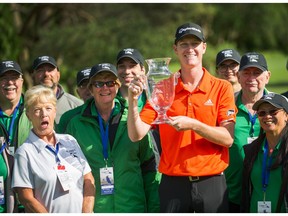 Jordan Niebrugge, standing here with volunteers, celebrates his first professional victory Sunday at the Freedom 55 Financial Open at Point Grey Golf & Country Club in Vancouver.